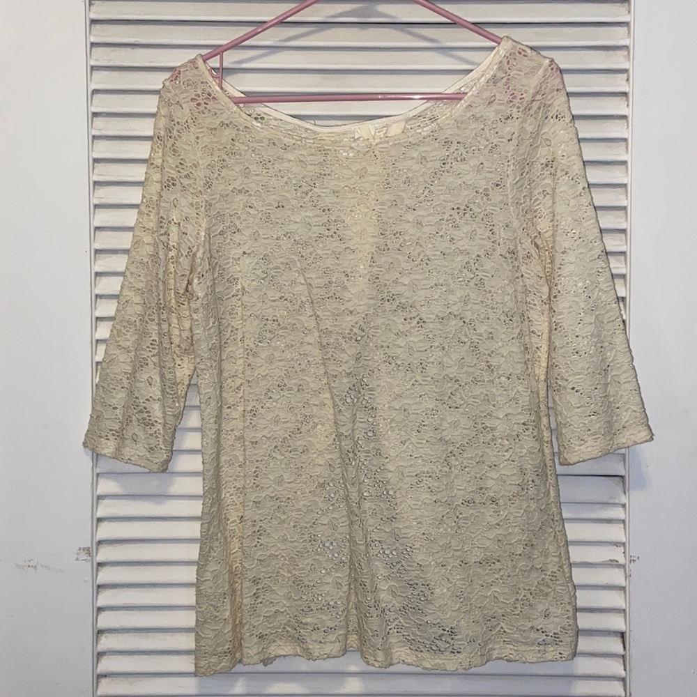Cream color lace blouse with 3/4 length sleeves and open back detail.